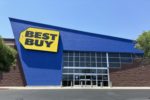 A BRIGHT BLUE AND YELLOW MALL STOREFRONT BEARS THE LOGO OF BEST BUY