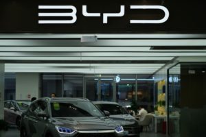 A GLEAMING CAR SHOWROOM BEARS THE LETTERS BYD ABOVE THE DISPLAY FLOOR