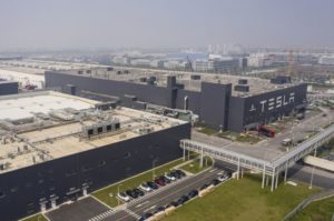 AN ARIAL SHOT OF A LARGE FACTORY COMPLEX UNDER SMOGGY SKIES