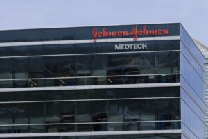 A large-windowed office building with "Johnson & Johnson" written across the top in red letters